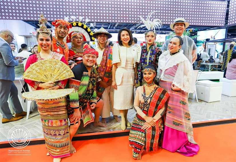 Secretary Christina Garcia Frasco with performers from Lahing Kayumanggi.